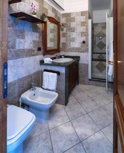 a bathroom with a sink and a toilet and a sink at Affittacamere Le Palme in Ospedaletti +44 photos