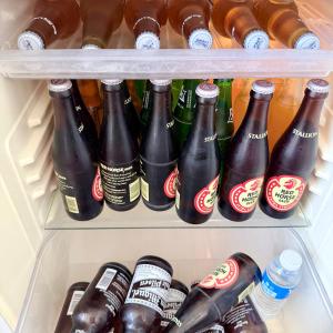 a refrigerator filled with lots of bottles of soda at BeaMare Suites in Bantay