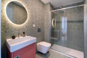 a bathroom with a toilet and a sink and a shower at Castle Boutique Studio in Leiria