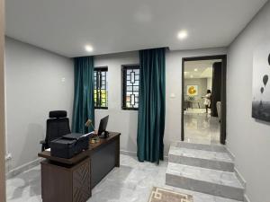 an office with a desk and green curtains at The Hill Manor in Ndola