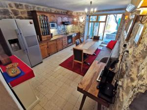 a kitchen with a couch and a table and a refrigerator at Authentico Deluxe Stari Grad in Stari Grad +22 photos