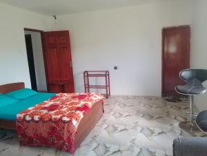 a bedroom with a bed and a chair in it at Oneli Homestay in Nuwara Eliya +1 photo