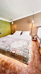 a bedroom with a large bed in a room at Лофт отель 11eleven in Shymkent