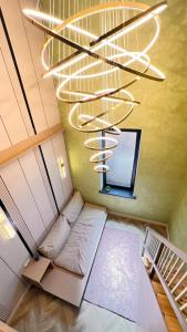 a room with a bed under a chandelier at Лофт отель 11eleven in Shymkent