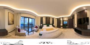 a hotel room with a bed and a tv at Al- Abasly Suites in Baghdād