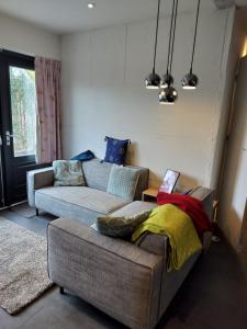 a living room with a couch and a table at Zonnehoek in Bruinisse
