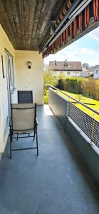 a bench sitting on the balcony of a house at Ferienwohnung Rütschlin in Nollingen