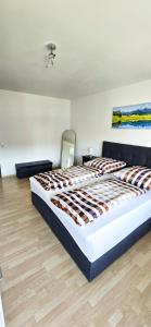 a bedroom with a large bed in a room at Ferienwohnung Rütschlin in Nollingen