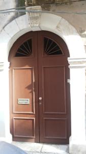 a large brown door with an arch in a building at Mareluna in Syracuse