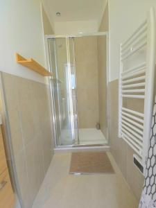 a shower with a glass door in a bathroom at La Tour d'Harfleur 1 in Caudebec-en-Caux +32 photos