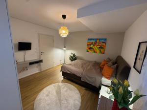 a living room with a bed and a couch at Schöne Wohnung mit eigenem Eingang Souterrain in Walldorf