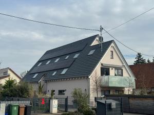 a house with solar panels on the roof at Schöne Wohnung mit eigenem Eingang Souterrain in Walldorf