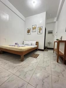 a large white room with a bed in it at Dodong homestay 2 in General Luna