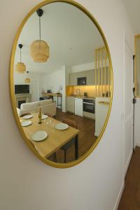 a living room with a table and a mirror at La Tour d'Harfleur 1 in Caudebec-en-Caux