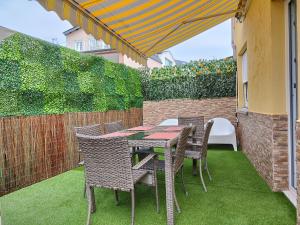 a patio with a table and chairs and a fence at BALCON DEL EO in Ribadeo