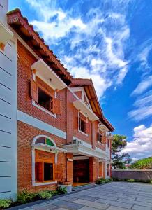 a brick building with a blue sky in the background at Sabi House Danu, Family Home near Prawirotaman in Timuran