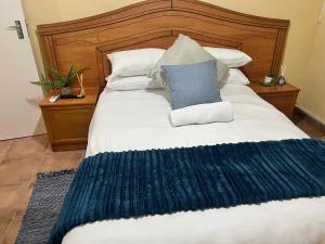 a large bed with a blue rug on it at Dube Villa in KwaDukuza