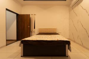 a bedroom with a bed in a room at Babji villa in Kolhapur Airport