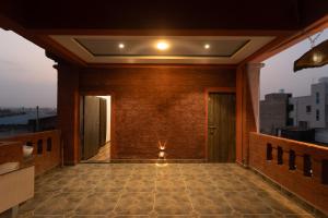 an empty corridor of a building with a light on the ceiling at Babji villa in Kolhapur Airport