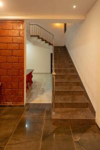 a staircase in a room with a brick wall at Babji villa in Kolhapur Airport