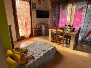 a little girl laying on a bed in a living room at Il Giardino di Bronto-lo in Crosare