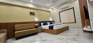 a hotel room with a bed and a couch at Royal Palace in Chāvasseri