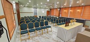 a conference room with blue chairs and a table at Royal Palace in Chāvasseri