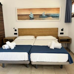 two beds sitting next to each other in a room at Don Carlos in Paguera +53 photos