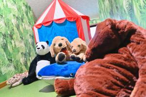a group of stuffed animals sitting on a bed at リトリート禅の宿 in Owariasahi +114 photos