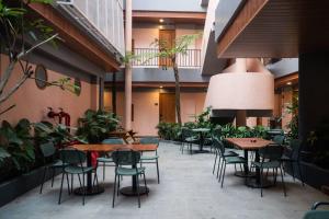 an empty courtyard with tables and chairs in a building at Liberta Malioboro North in Yogyakarta