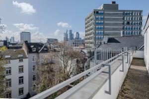 a view of the city from the balcony of a building at Hotel Mondial Comfort - Frankfurt City Centre in Frankfurt