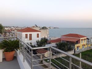 a balcony of a building with a view of the ocean at VueSurMer Amarynthos in Amarynthos