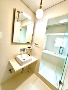 a bathroom with a sink and a mirror and a shower at Pet Friendly Spacious 3 BHK Penthouse in Mumbai