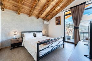a bedroom with a bed and a balcony at VILA K3 Podgorica in Podgorica