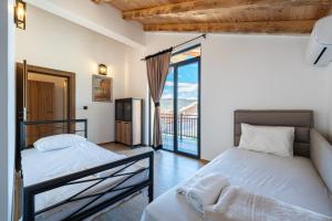 a bedroom with two beds and a balcony at VILA K3 Podgorica in Podgorica