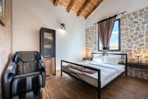 a bedroom with a bed and a rock wall at VILA K3 Podgorica in Podgorica