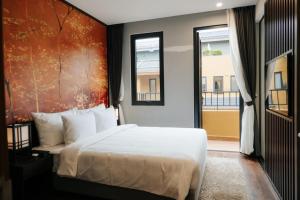 a bedroom with a bed and a large window at Wyndham Lynn Times Thanh Thuỷ Phú Thọ Hotel in Xuân Vi