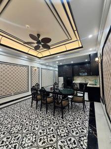 a dining room with a table and chairs at Indocharm Villa Cat Ba in Cat Ba