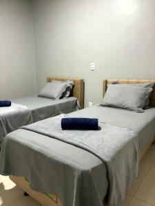 two beds with blue pillows on them in a room at DUNAS RESIDENCE CASA 12 in Santo Amaro +47 photos