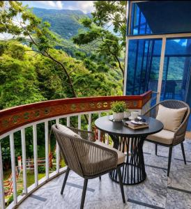 a patio with a table and chairs on a balcony at Hotel Red Roof & Restaurant in Abbottabad
