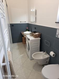 a bathroom with a toilet and a sink at Mama Etna in Belpasso