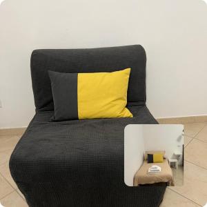 a black and yellow couch with a yellow pillow at Casa Paoli in Salerno