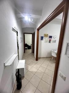 a hallway with a table and a room at Casa Paoli in Salerno