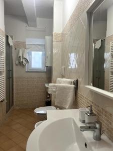 a bathroom with a white sink and a toilet at Casa Paoli in Salerno
