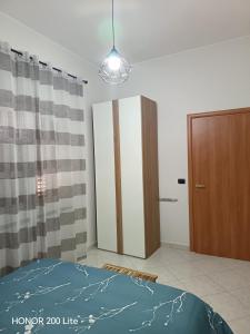 a bedroom with a bed and a closet and a door at Mama Etna in Belpasso