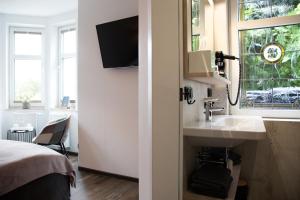 a bathroom with a sink and a window and a bed at Vergissmeinnicht in Oberhof +91 photos