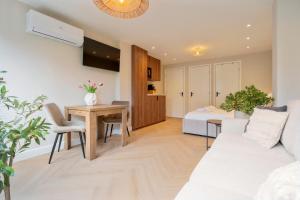 a living room with a couch and a table at Boetiek ManjaFiek in Zandvoort