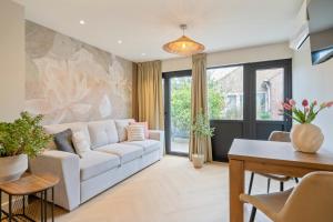 a living room with a white couch and a table at Boetiek ManjaFiek in Zandvoort