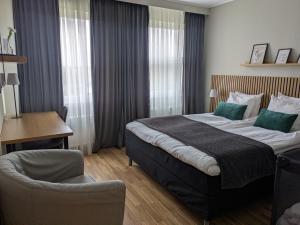 a hotel room with a bed and a chair at Hotell Marieberg in Kristinehamn +65 photos