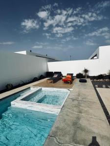 a swimming pool in the backyard of a house at Stylish and comfortable Villa Anna in Villaverde in Lajares